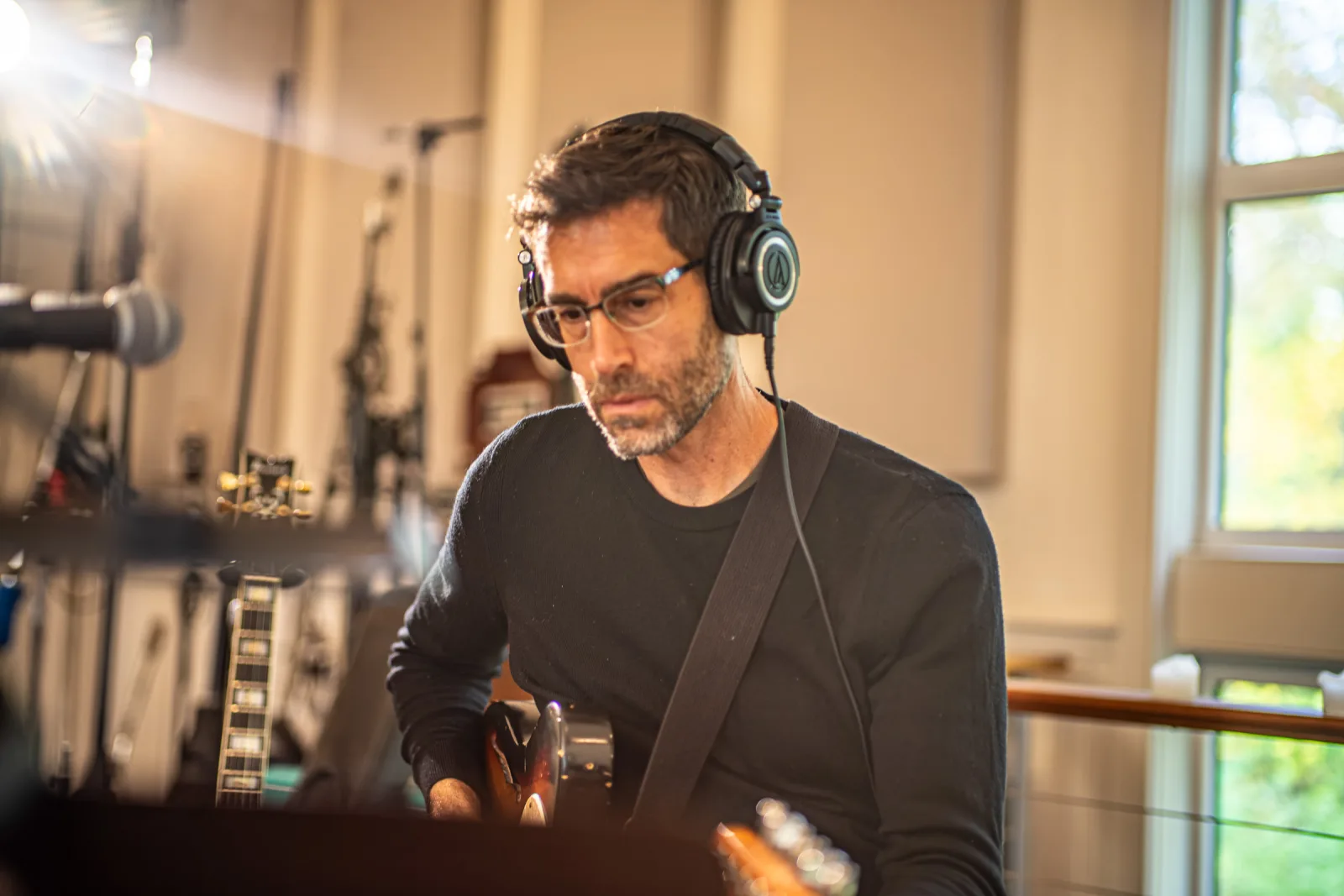 Guitarist tracking with Audio-Technica headphones at Studio C